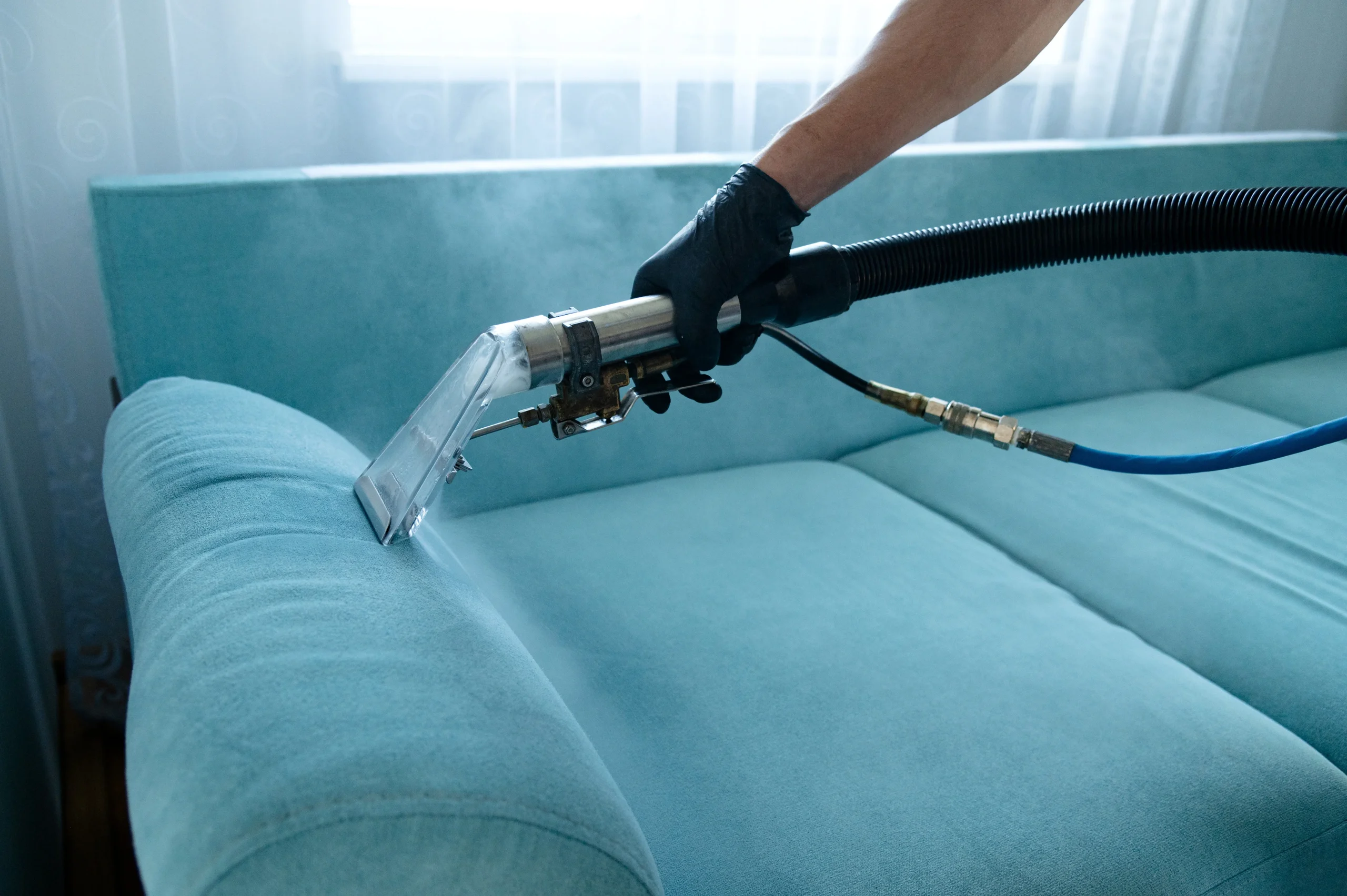a cleaner cleaning a sofa for end of tenancy cleaning Camden NW1