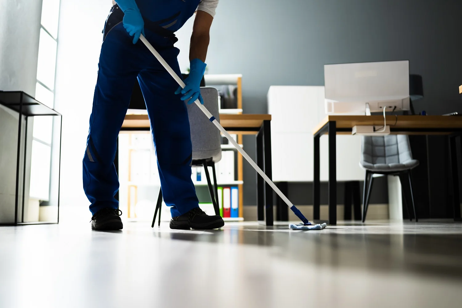 a cleaner mopping the floor for end of tenancy cleaning Hackney E8